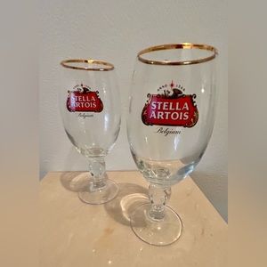 Two Stella Artois glasses with gold rim.
